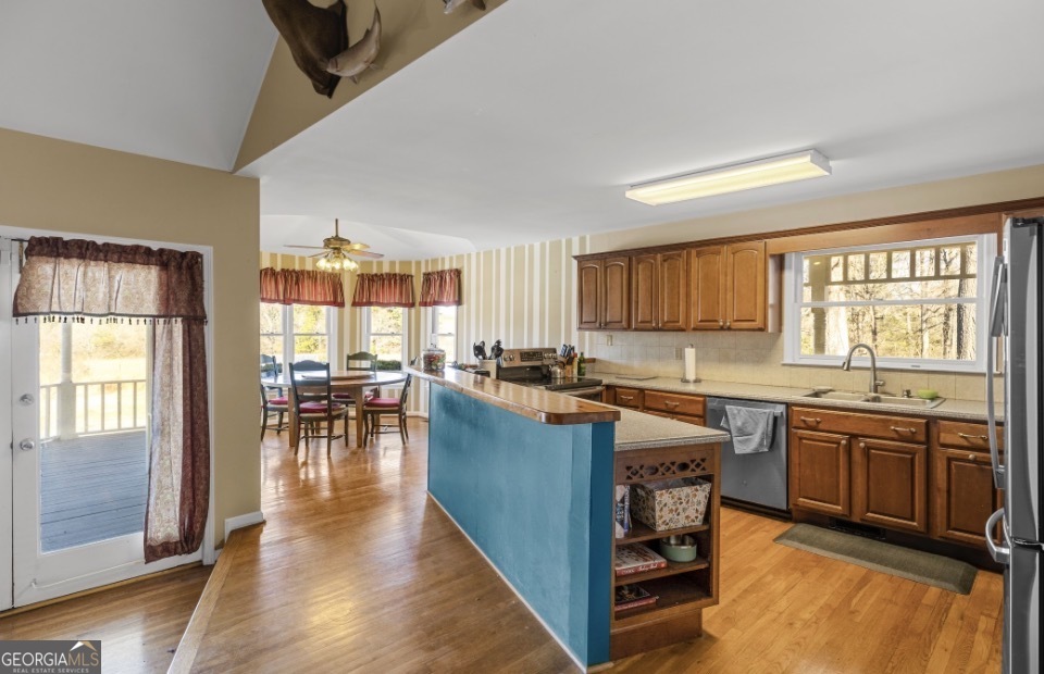 1776 Wax Road Southeast Silver Creek, GA 30173 - Photo 15 of 45 a kitchen with lots of counter top space and dining table