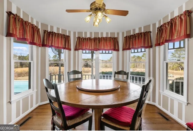 a dining room with furniture a chandelier and window