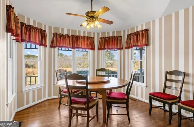 a view of a dining room with furniture window and wooden floor