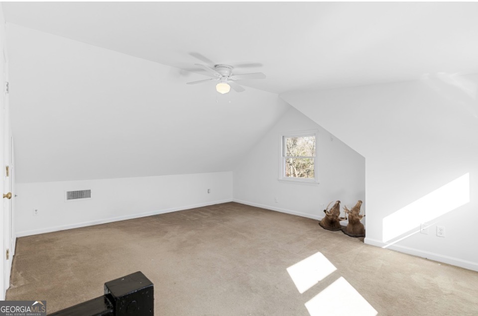 1776 Wax Road Southeast Silver Creek, GA 30173 - Photo 27 of 45 an empty room with windows and ceiling fan