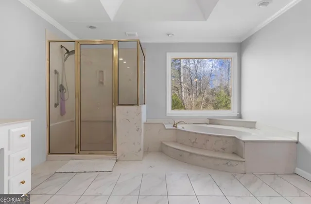 a bathroom with a bathtub and shower