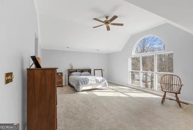 a bedroom with a bed and glass door