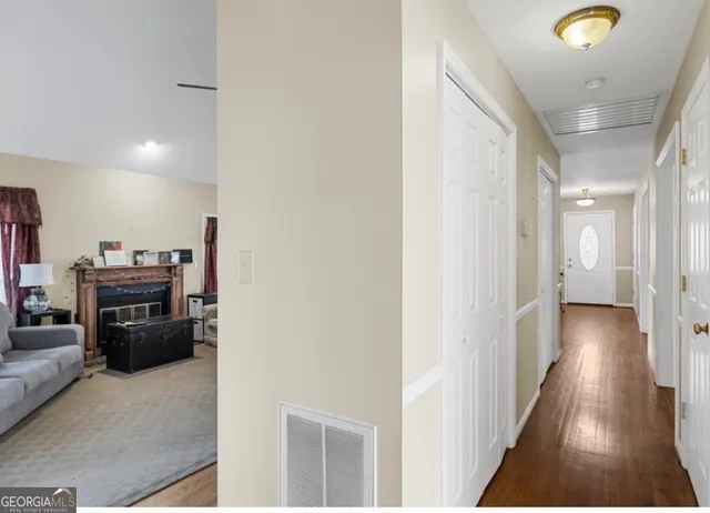a view of a hallway with wooden floor