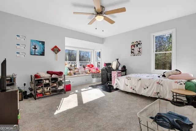 a bedroom with bed and a large window