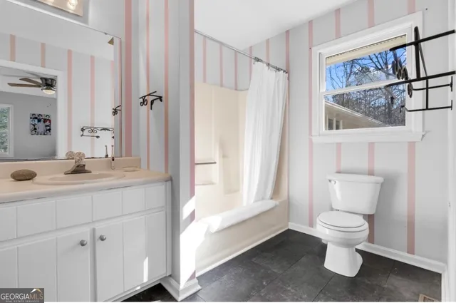 a bathroom with a toilet sink and shower