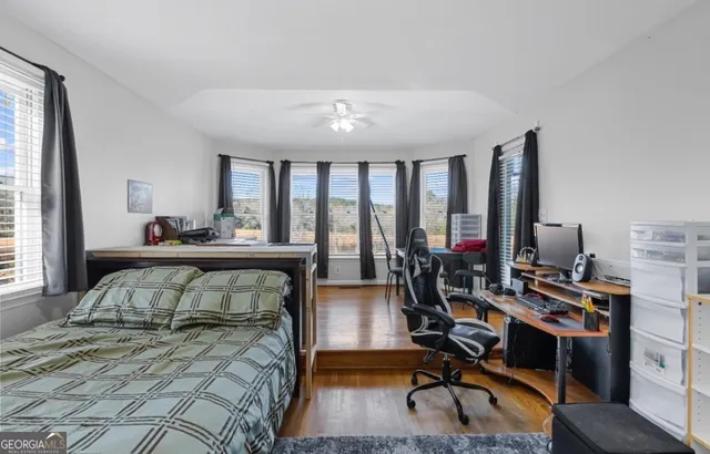 a bedroom with furniture and a large window