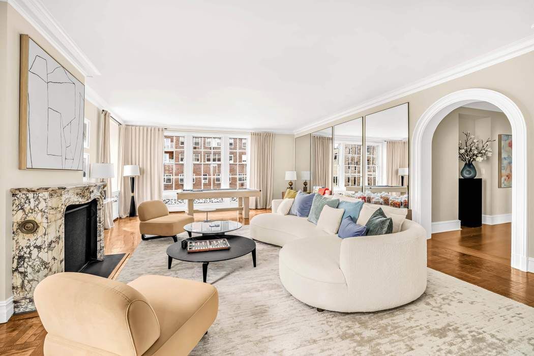 39 East 79th Street, Unit TRIPLEX 12/13/14 Manhattan, NY 10075 - Photo 10 of 33 a living room with fireplace furniture and a large window