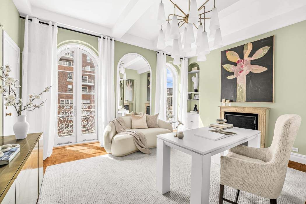 39 East 79th Street, Unit TRIPLEX 12/13/14 Manhattan, NY 10075 - Photo 12 of 33 a living room with furniture a fireplace and a chandelier