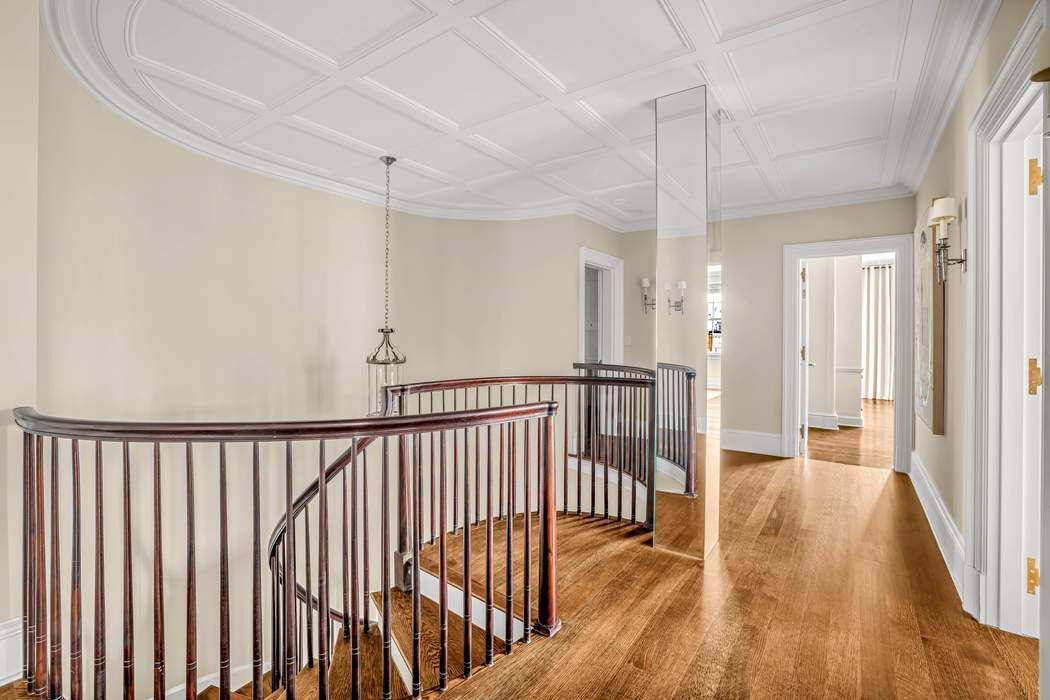 39 East 79th Street, Unit TRIPLEX 12/13/14 Manhattan, NY 10075 - Photo 13 of 33 a view of a hallway with wooden floor