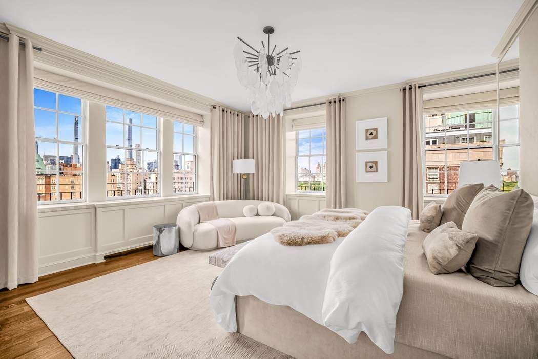 39 East 79th Street, Unit TRIPLEX 12/13/14 Manhattan, NY 10075 - Photo 14 of 33 a bed room with two beds and a large window