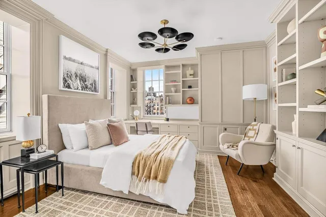 a living room with a couches and chandelier