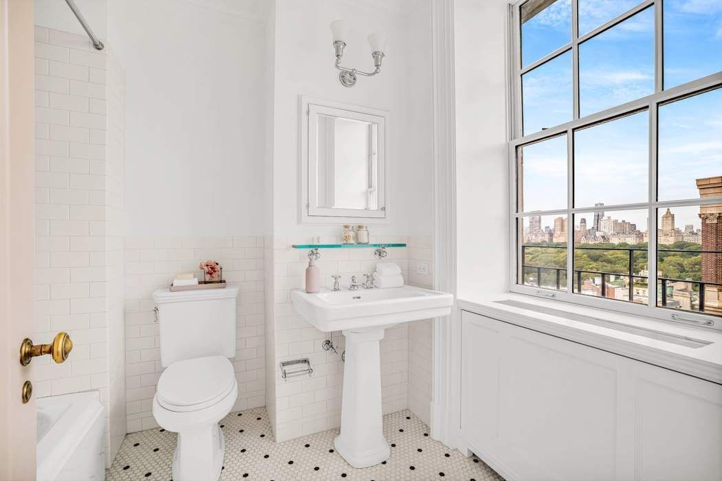 39 East 79th Street, Unit TRIPLEX 12/13/14 Manhattan, NY 10075 - Photo 20 of 33 a bathroom with a sink a toilet and a window