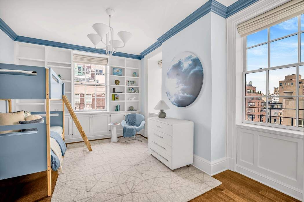 39 East 79th Street, Unit TRIPLEX 12/13/14 Manhattan, NY 10075 - Photo 21 of 33 a bedroom with a large bed and a window