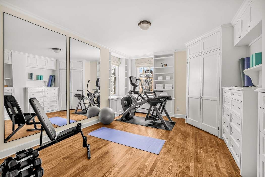 39 East 79th Street, Unit TRIPLEX 12/13/14 Manhattan, NY 10075 - Photo 26 of 33 a view of a livingroom with furniture and a hardwood floor