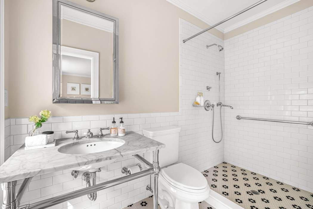 39 East 79th Street, Unit TRIPLEX 12/13/14 Manhattan, NY 10075 - Photo 28 of 33 a bathroom with a sink toilet and shower