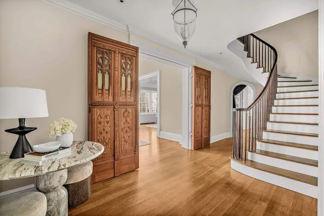 a dining room with furniture a chandelier and wooden floor