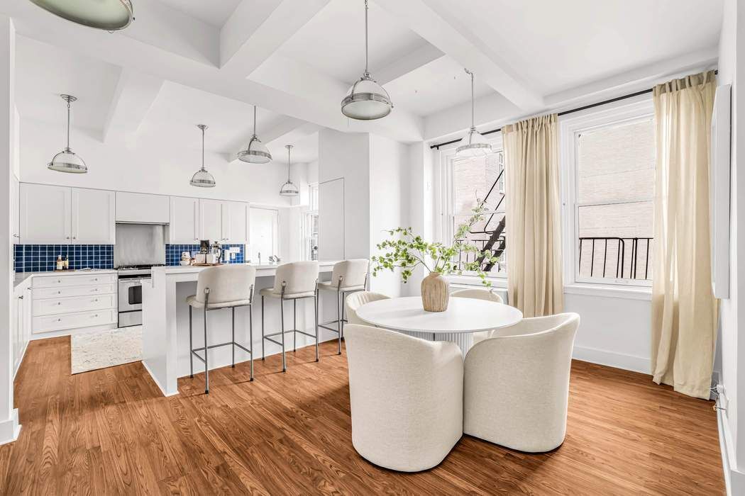 39 East 79th Street, Unit TRIPLEX 12/13/14 Manhattan, NY 10075 - Photo 7 of 33 a living room with kitchen island granite countertop furniture and a fireplace