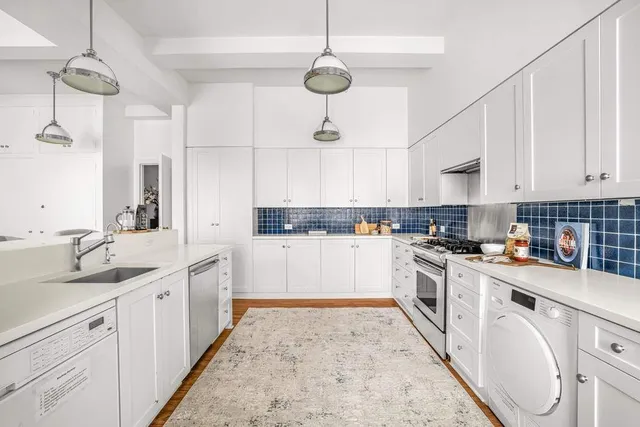 a living room with kitchen island granite countertop furniture and a fireplace