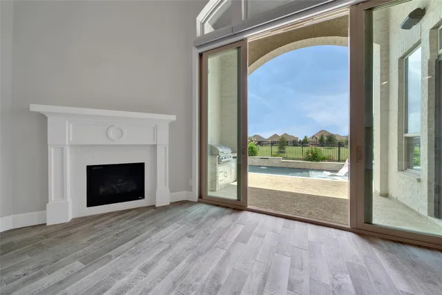 a living room with furniture a flat screen tv and a large window
