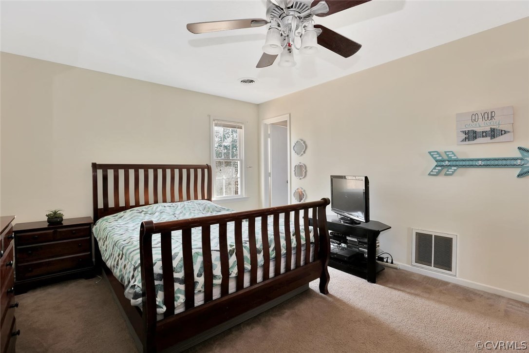 9905 Brenspark Road Chesterfield, VA 23832 - Photo 13 of 19 a bed room with a bed and a chandelier
