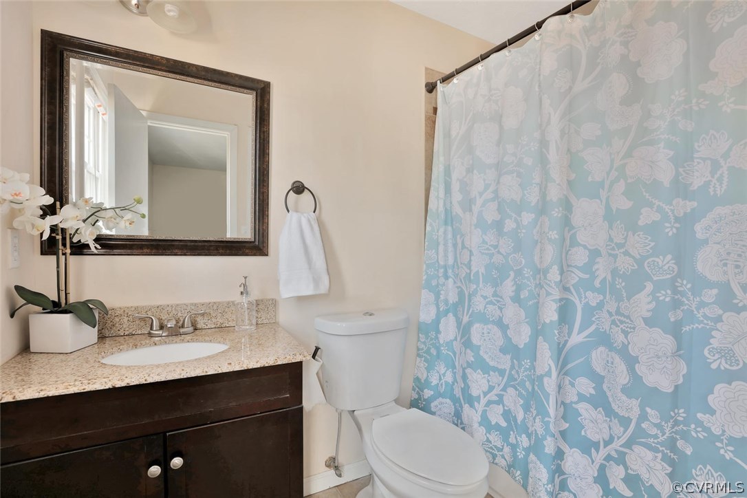 9905 Brenspark Road Chesterfield, VA 23832 - Photo 14 of 19 a bathroom with a granite countertop sink a toilet and a mirror