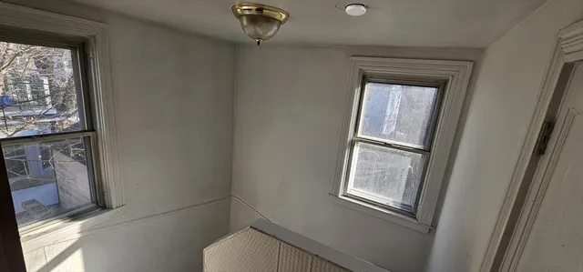 a view of a yard with wooden fence