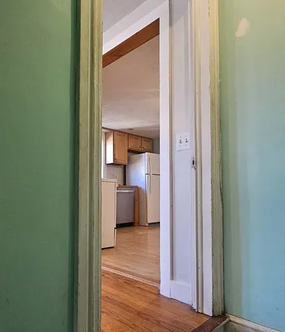 a view of room with window and wooden floor