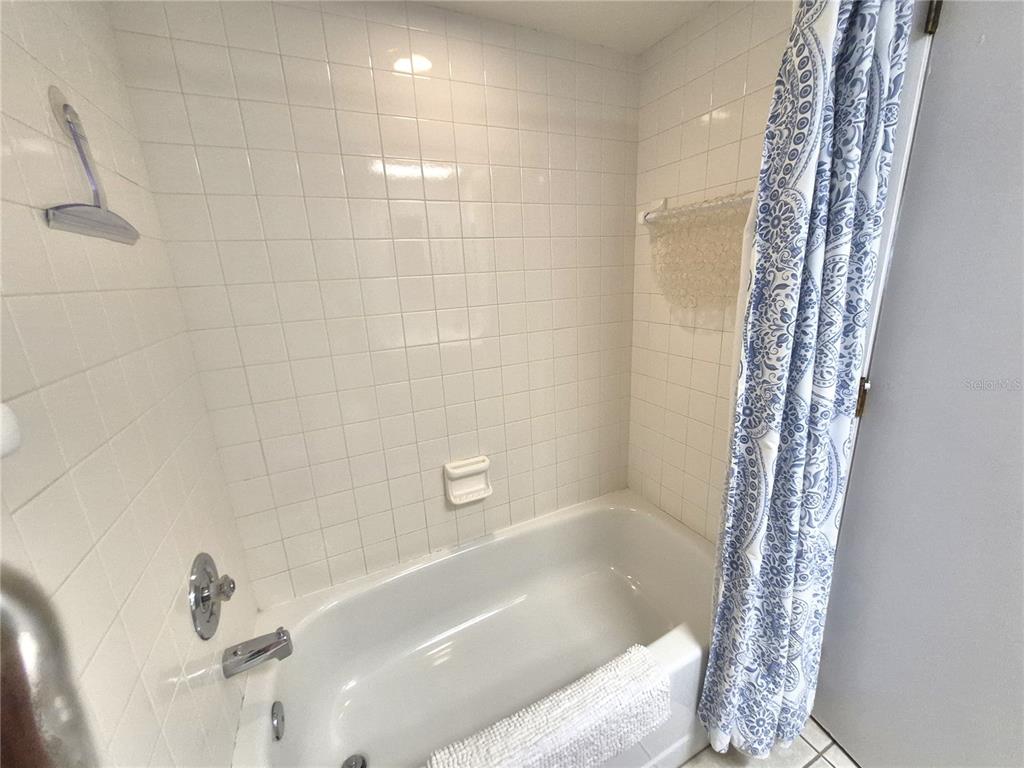107 Windward Place, Unit 107 Oldsmar, FL 34677 - Photo 31 of 34 a bathroom with a bathtub and shower