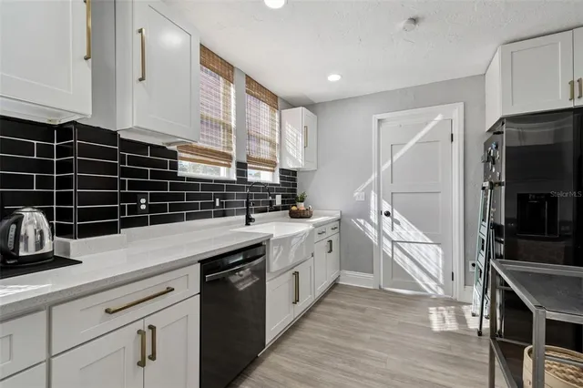a kitchen with a sink a stove and cabinets