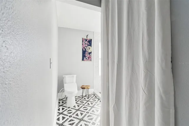 a bathroom with a toilet and a shower