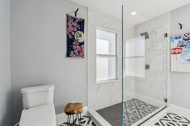 a bathroom with a shower and a sink