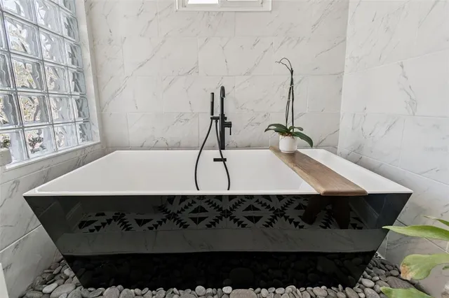 a room with table chairs and white walls