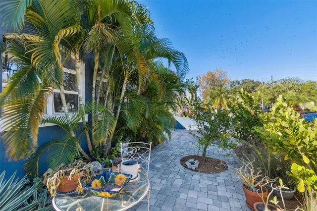 a view of a patio with a table and chairs under an umbrella