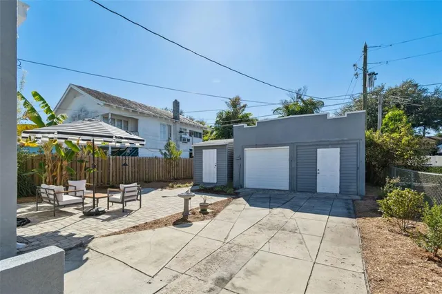 a view of a patio with table and chairs with wooden floor and plants