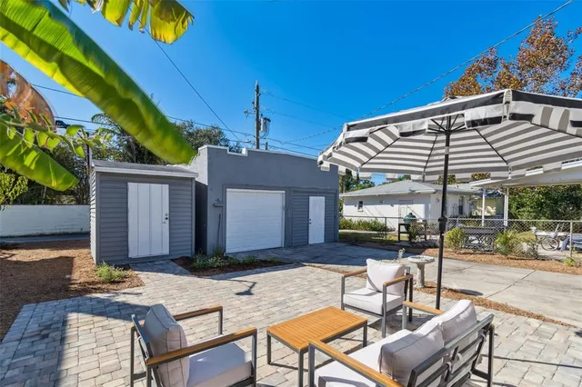a view of a backyard with sitting area