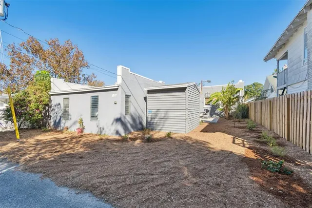an aerial view of residential houses with outdoor space and parking