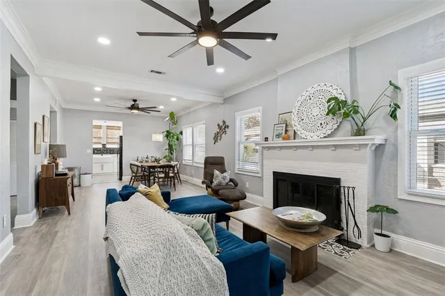 a living room with furniture a fireplace and a window