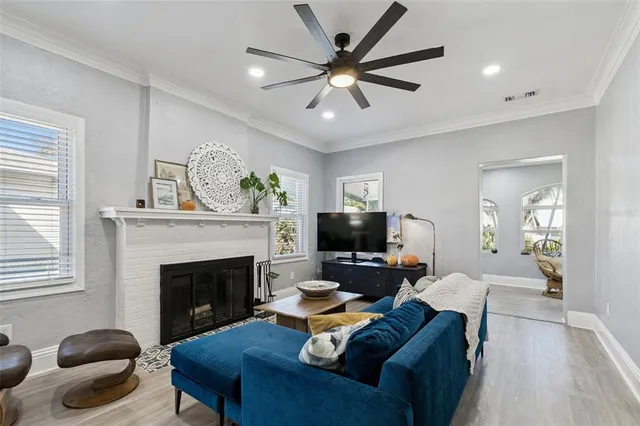 a living room with furniture a fireplace and a flat screen tv