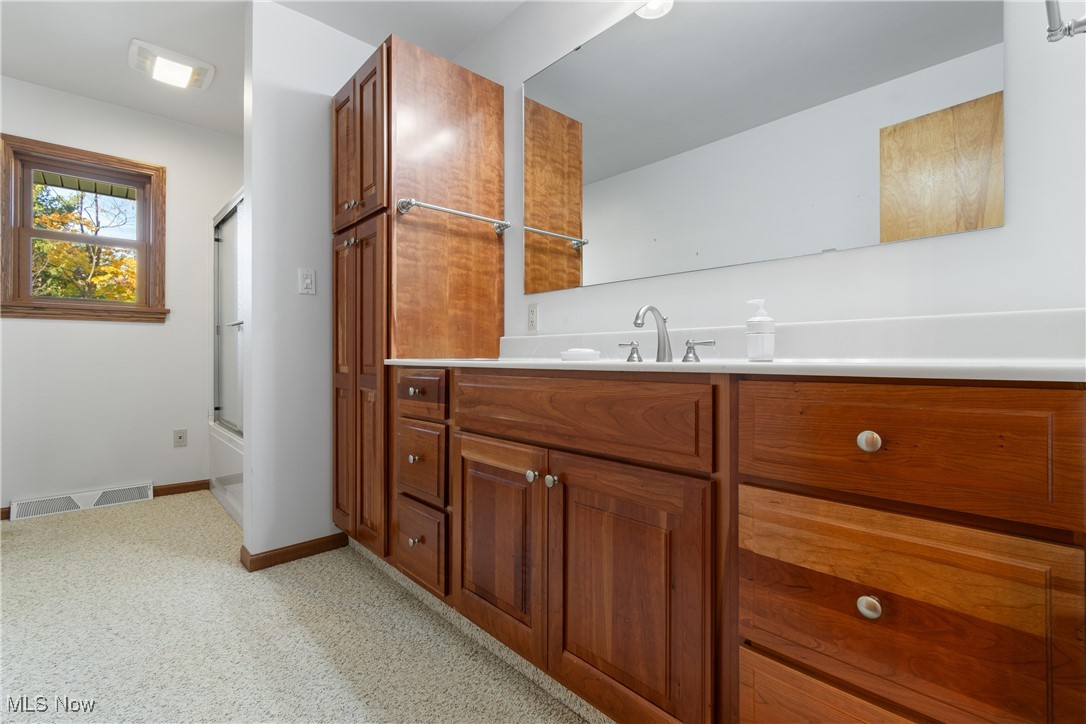 3240 Copley Road Akron, OH 44321 - Photo 20 of 35 Bathroom featuring vanity and combined bath / shower with glass door