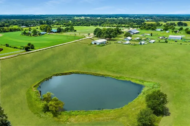 a view of a golf course with an ocean