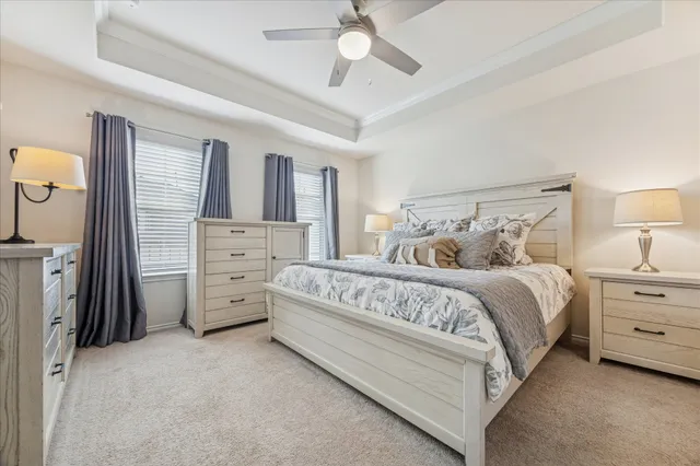 a spacious bedroom with a bed and a chandelier