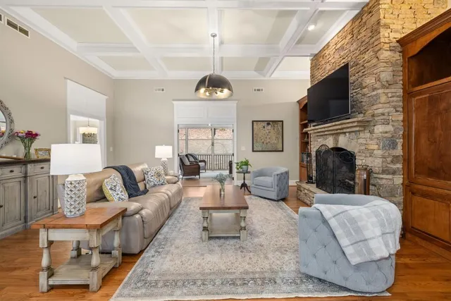 a living room with furniture a lamp and a chandelier