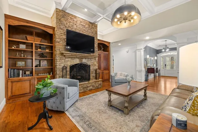 a kitchen with stainless steel appliances granite countertop a stove top oven a refrigerator a sink and dishwasher a oven with white cabinets