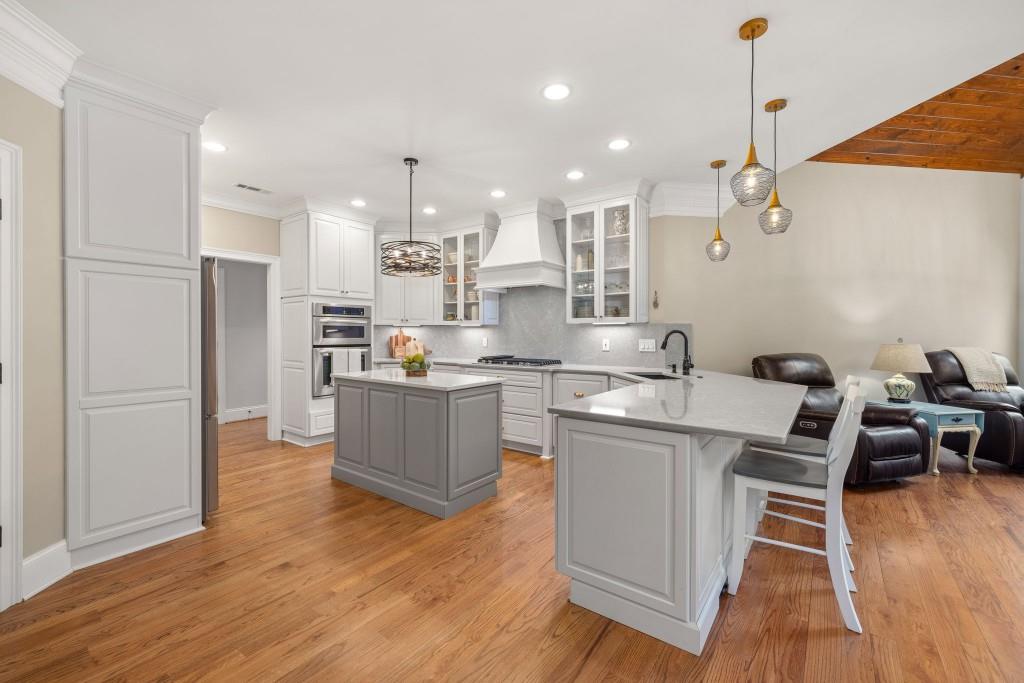 99 Madeline Anthony Road Dahlonega, GA 30533 - Photo 16 of 60 a kitchen with kitchen island stainless steel appliances a stove a sink a refrigerator and cabinets