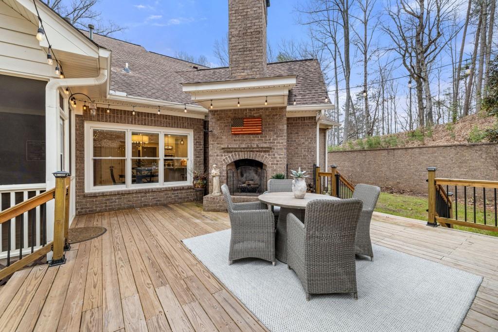 99 Madeline Anthony Road Dahlonega, GA 30533 - Photo 22 of 60 a view of a patio with couches table and chairs with wooden floor