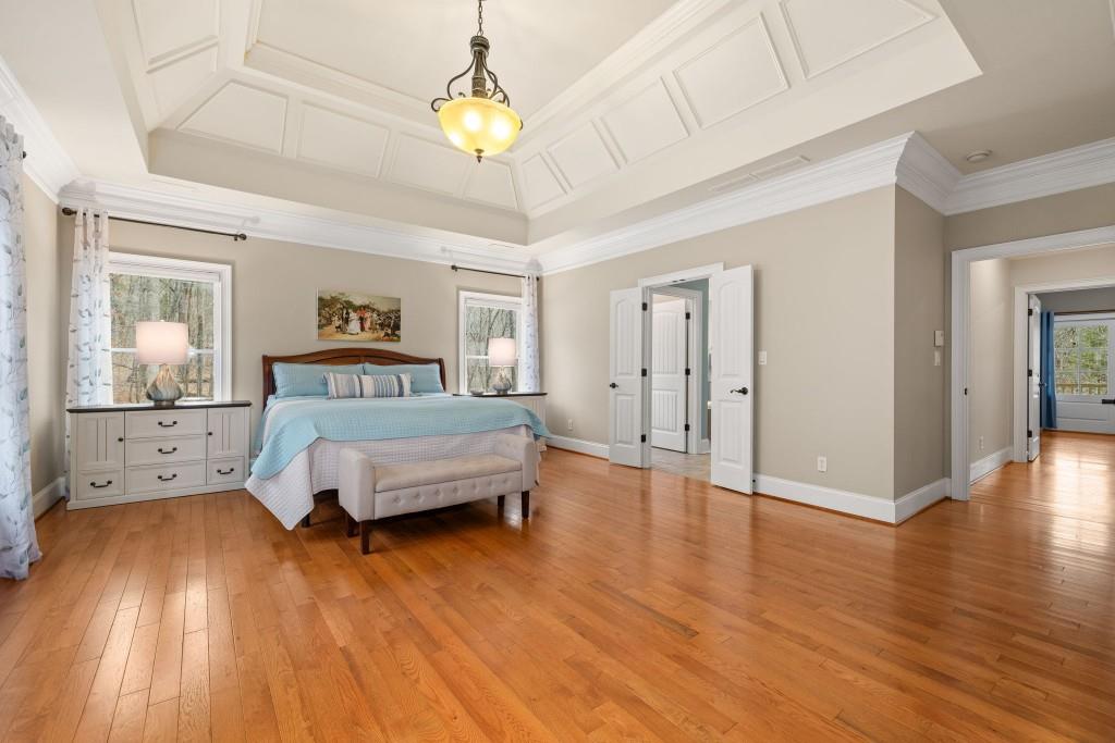 99 Madeline Anthony Road Dahlonega, GA 30533 - Photo 24 of 60 a spacious bedroom with a bed and wooden floor