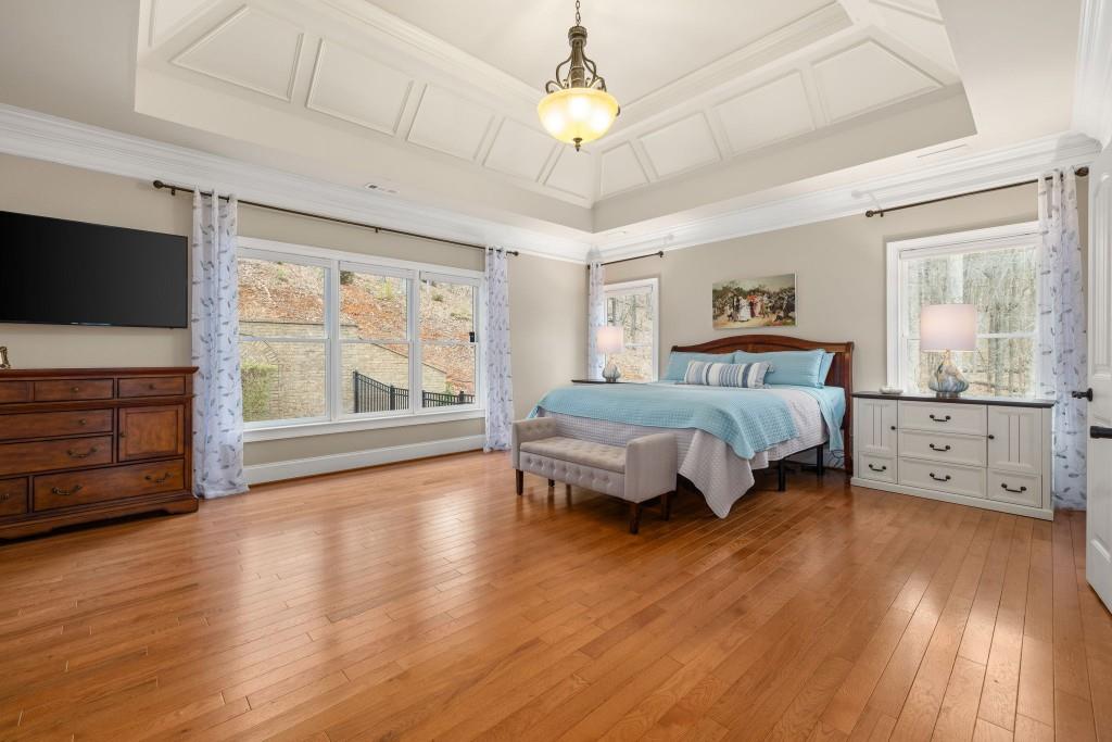 99 Madeline Anthony Road Dahlonega, GA 30533 - Photo 26 of 60 a spacious bedroom with a bed and a flat tv screen on dresser