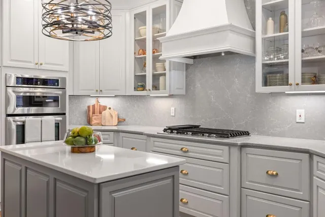 a kitchen with a stove cabinets and window