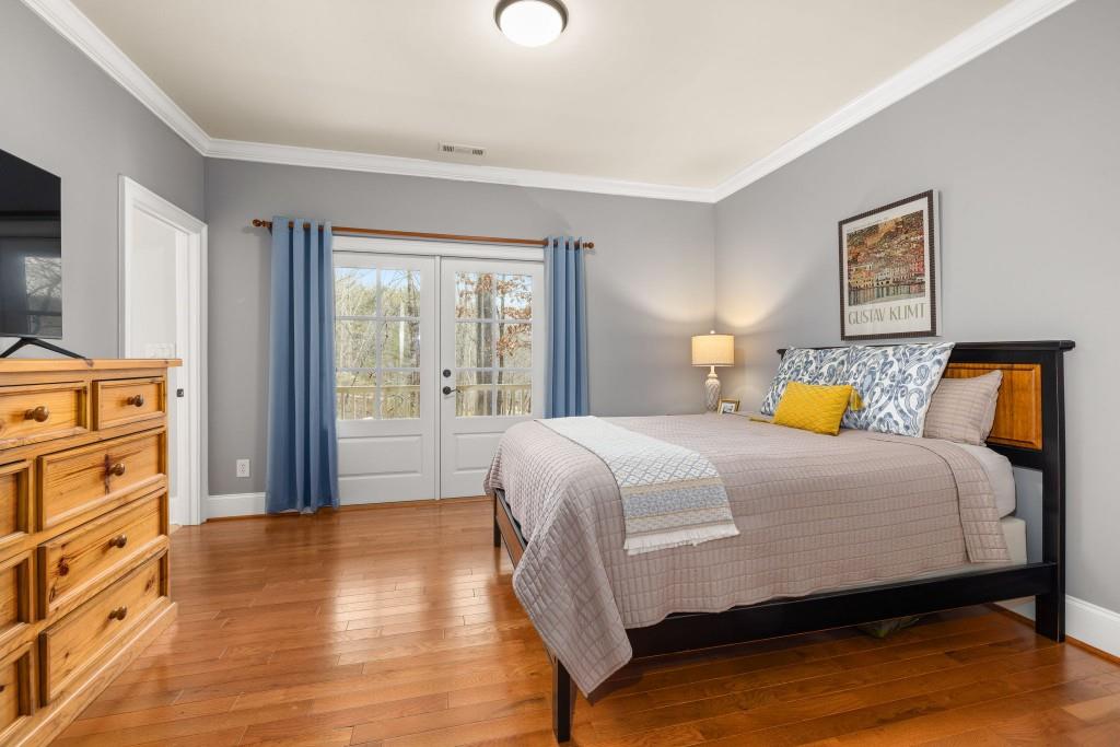 99 Madeline Anthony Road Dahlonega, GA 30533 - Photo 31 of 60 a bedroom with a bed and wooden floor