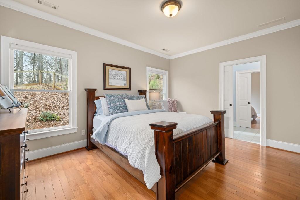 99 Madeline Anthony Road Dahlonega, GA 30533 - Photo 35 of 60 a bed sitting in a bedroom next to a window